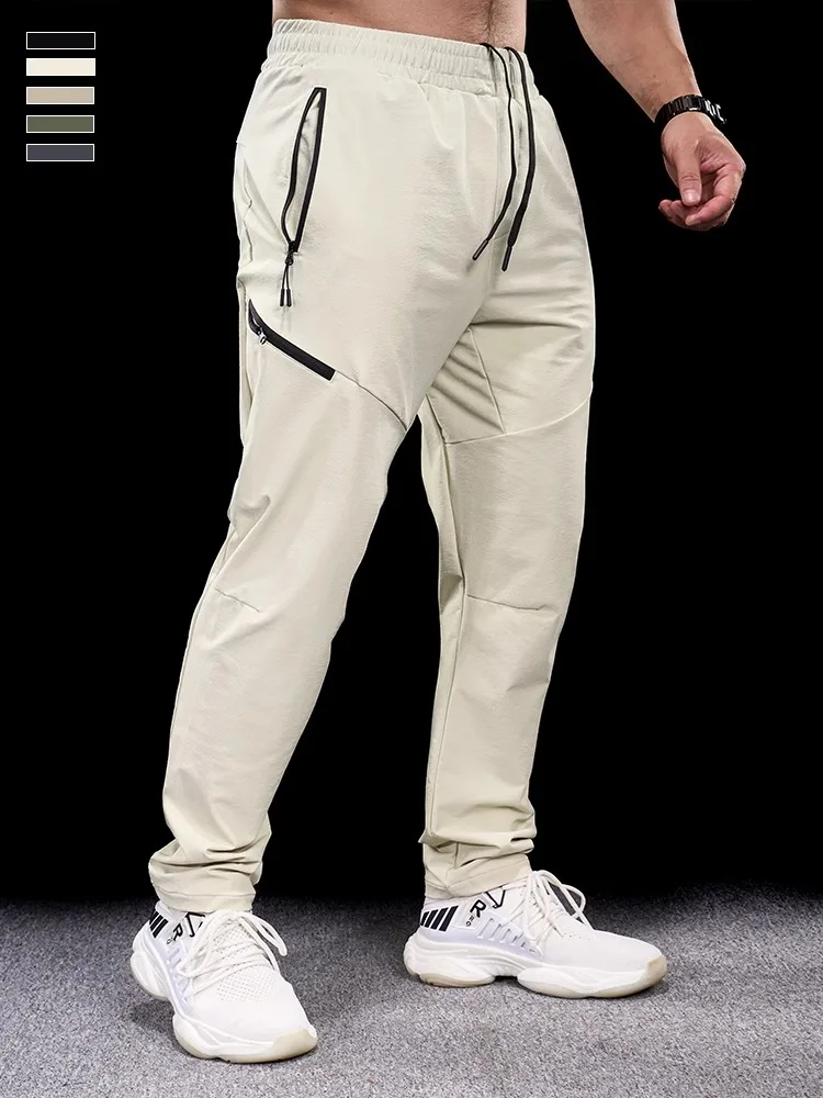 新しい秋冬男性速乾性スポーツカジュアルズボンジムフィットネスランニングトレーニング服マイクロ弾性ジッパーポケットパンツ