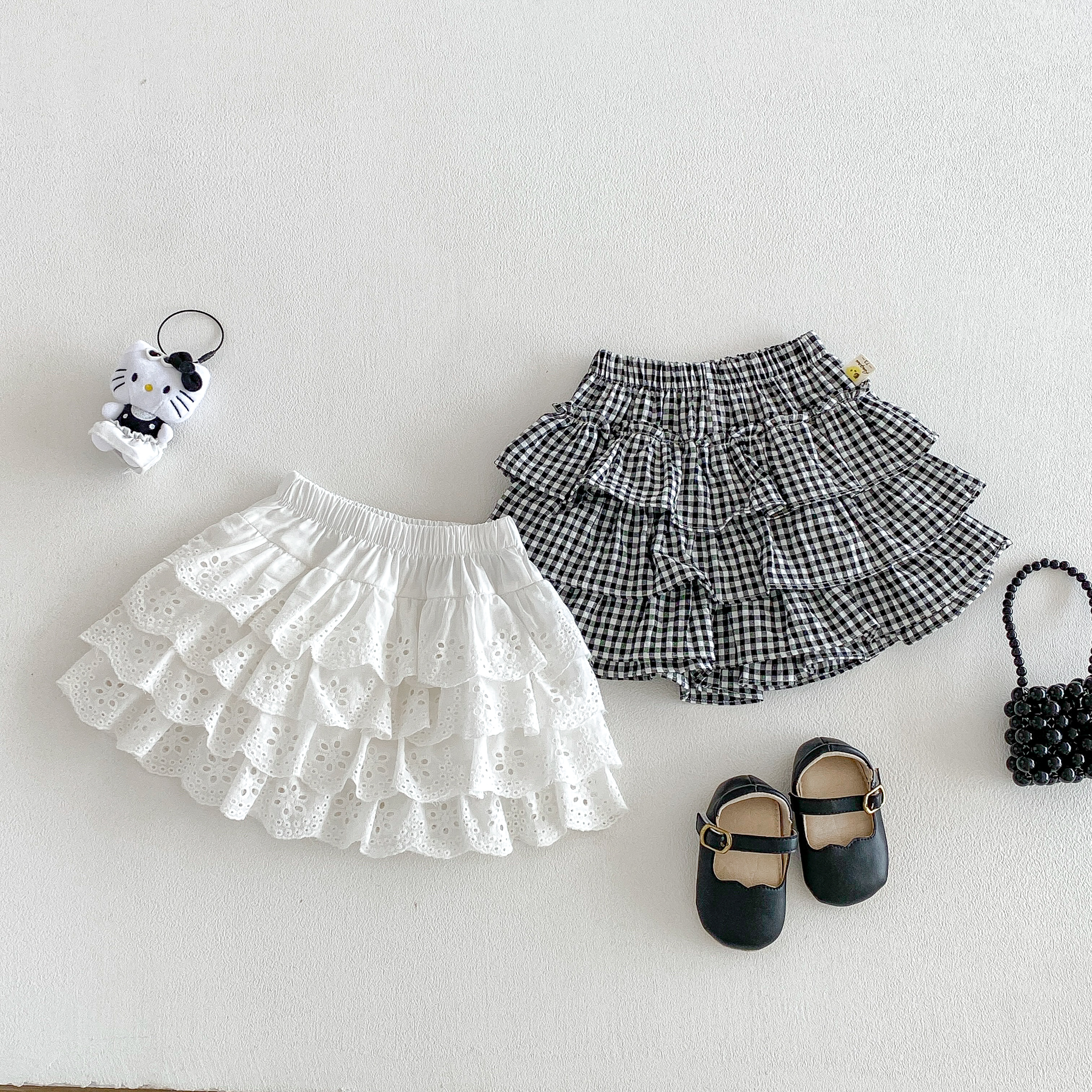 韓国風の新しい夏の幼児と幼児の甘いプリンセスの森のケーキプリーツスカートチェックハーフスカート多用途ドレスパンツ