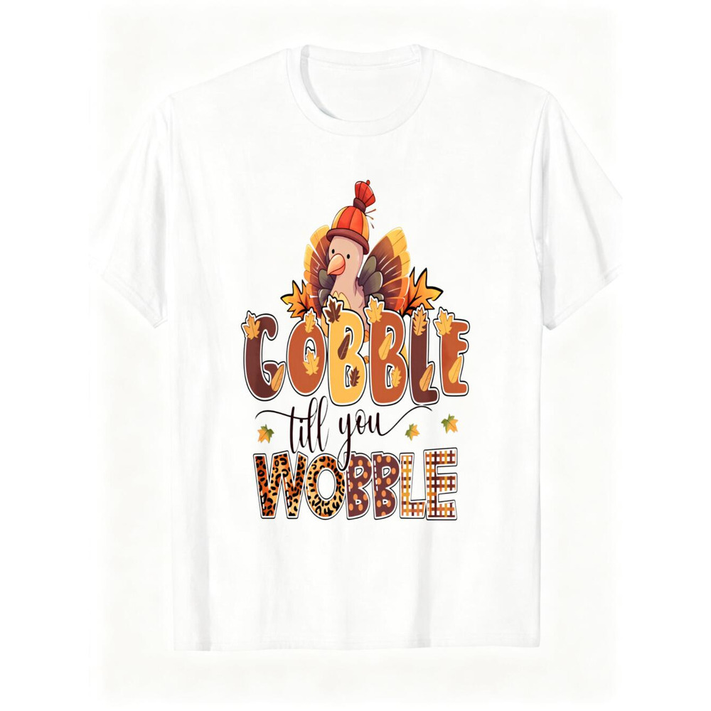 面白い感謝祭の七面鳥グラフィックTシャツ、「Gobble Till You Wobble」ヒョウとチェック柄のレタリングプリントTシャツ、かわいい秋のホリデーシーズンシャツ、男女兼用のお祝いユニセックスカジュアルトップ、ソフトコットンウィット