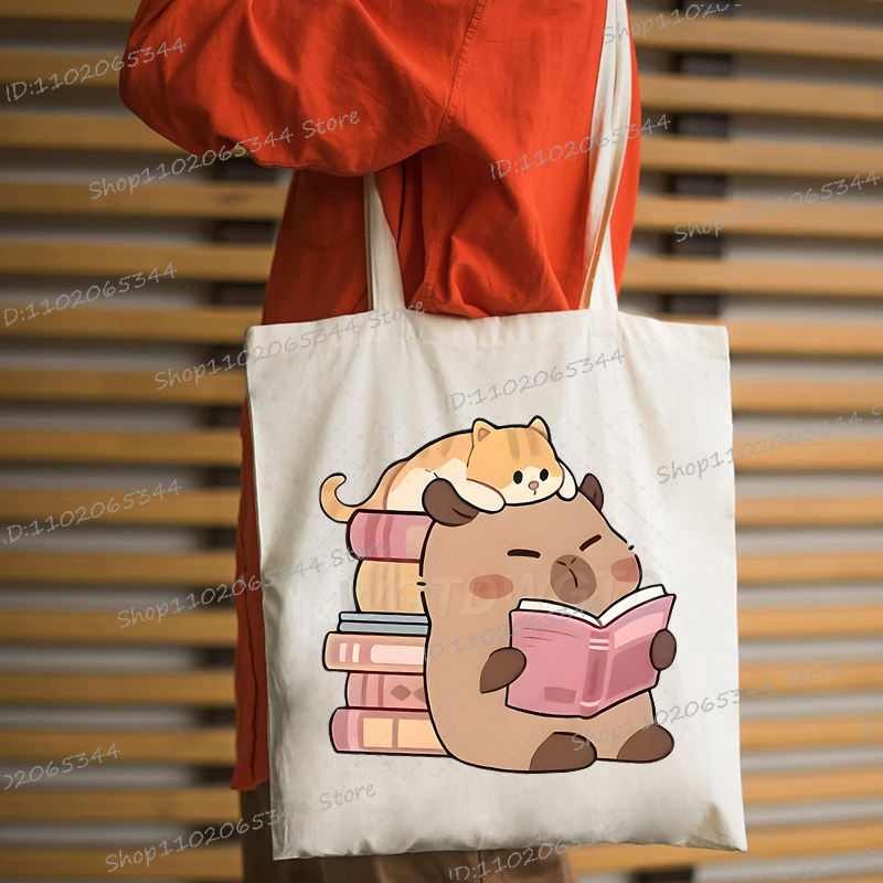 カピバラと本キャンバストートバッグ大容量漫画学生ショルダーバッグポータブル環境に優しいショッピングバッグ